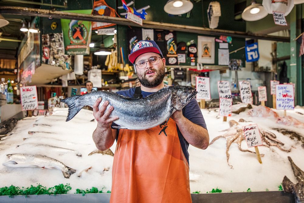 A fishmonger displays part of the catch of the day at Seattle, Washington's, Pike Place Market. Original image from Carol M.…