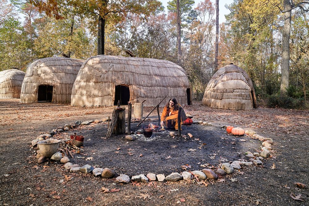 Historical interpreter in the re-created Powhatan Indian Village at the Jamestown Settlement, Virginia. Original image from…