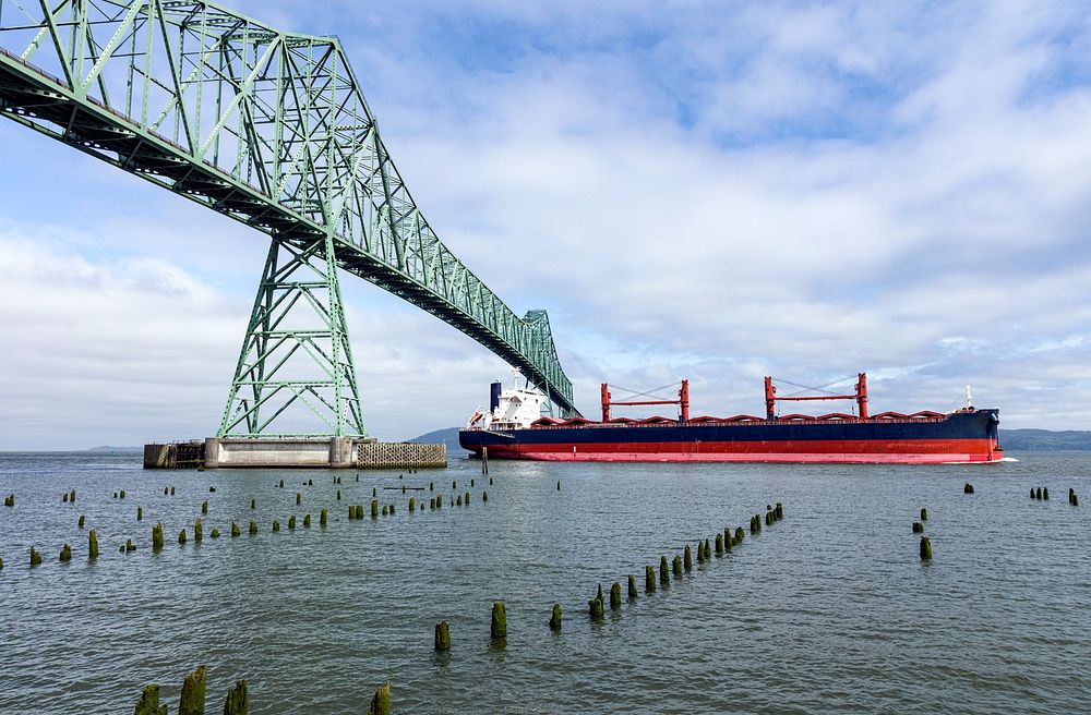 An freighter passing under a bridge near the mouth of the Columbia River. Original image from Carol M. Highsmith&rsquo;s…