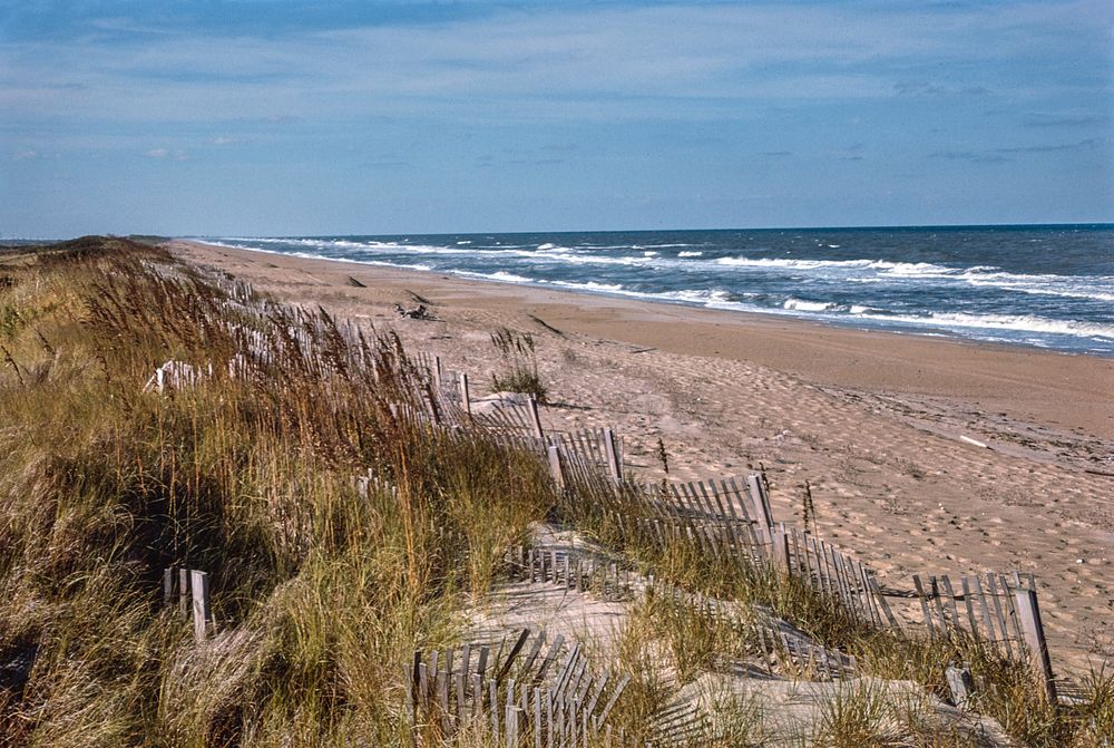 View of beach and ocean from Sanderling Inn, Duck, North Carolina (1985) photography in high resolution by John Margolies.…