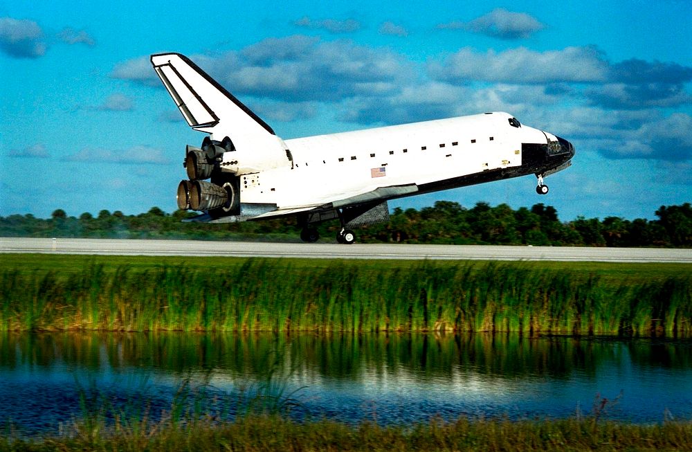 The Space Shuttle orbiter Atlantis touches down on Runway 15 of the KSC Shuttle Landing Facility to complete the nearly 11…