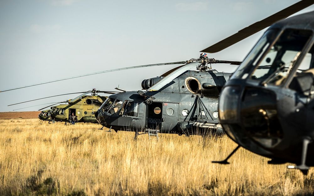 Russian search and rescue MI-8 helicopters are seen at the landing site of the Soyuz TMA-08M spacecraft in a remote area…