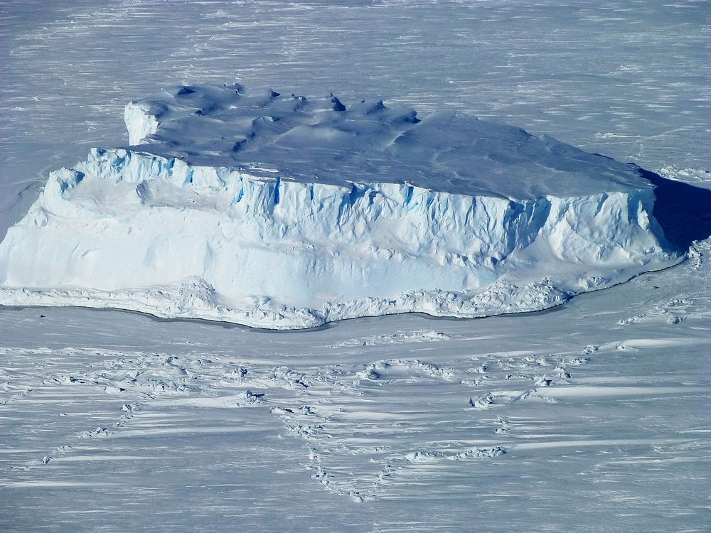 An iceberg trapped in sea ice in the Amundsen Sea. Original from NASA. Digitally enhanced by rawpixel.