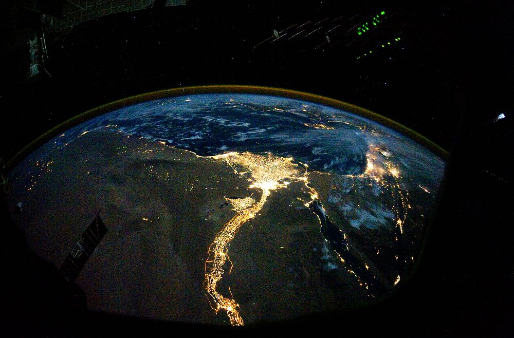 Night time photo featuring the bright lights of Cairo and Alexandria, Egypt on the Mediterranean coast. The Sinai Peninsula…