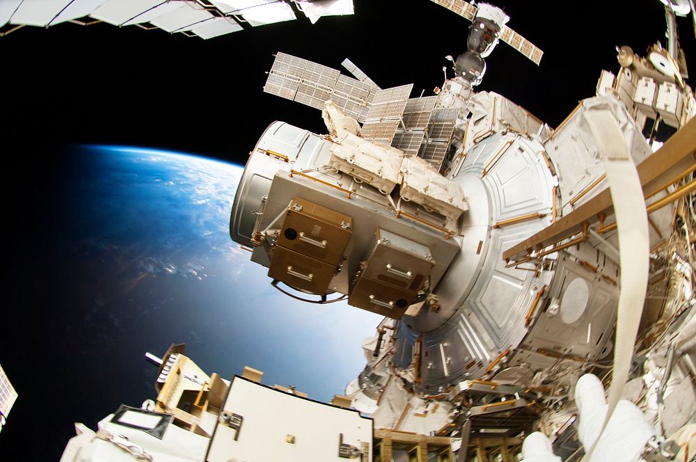 Astronauts working outside the space station's Quest airlock in Oct 7, 2014. Original from NASA. Digitally enhanced by…