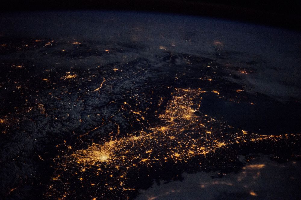 "Beautiful night pass over Italy, Alps and Mediterranean." Original from NASA. Digitally enhanced by rawpixel.