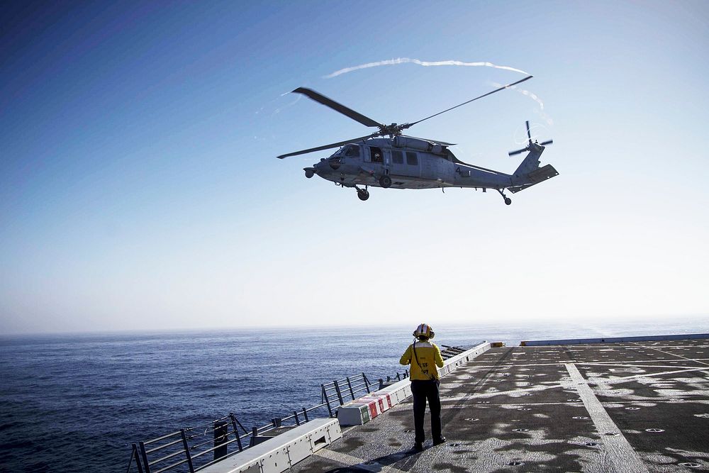 An H60-S helicopter takes off from the deck of the USS Anchorage during the first day of Orion Underway Recovery Test 3…