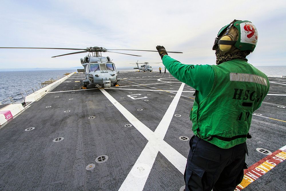 SAN DIEGO, Calif. &ndash; A member of the Helicopter Sea Combat Squadron 8 signals to the pilot in an H60-S Seahawk…