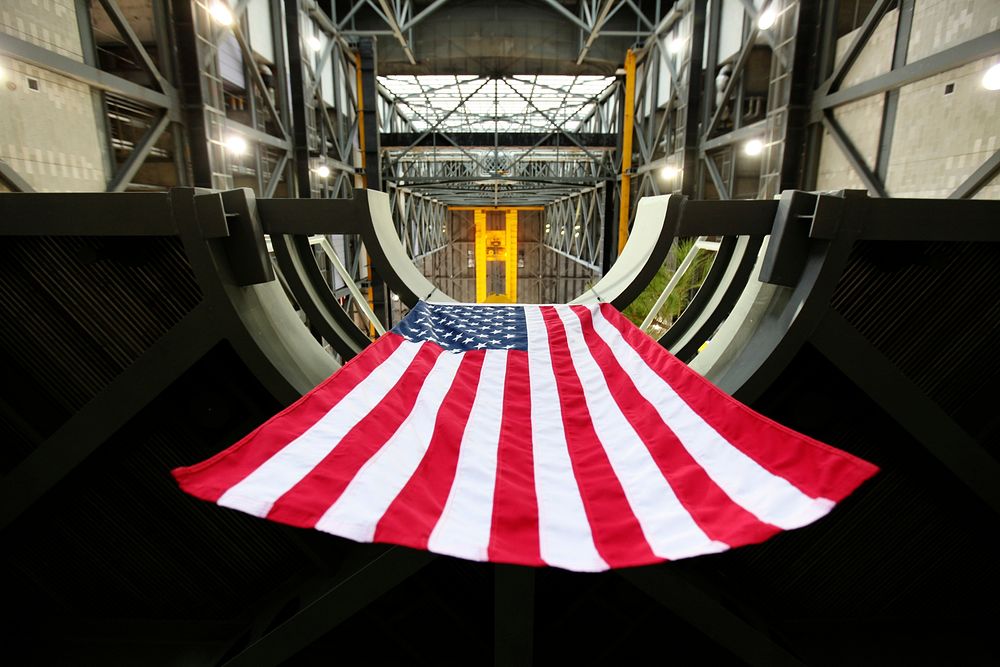 In a view from below, the American flag is in view hanging from the final work platform, A north, as the platform is lifted…