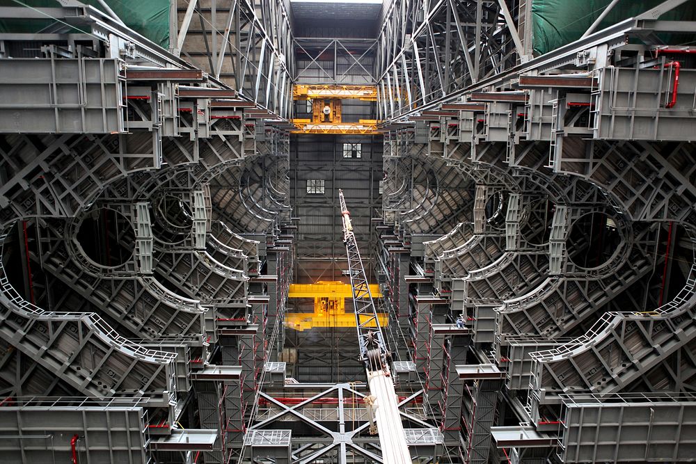 High up in the Vehicle Assembly Building (VAB) at NASA's Kennedy Space Center in Florida, an overhead crane has lowered the…