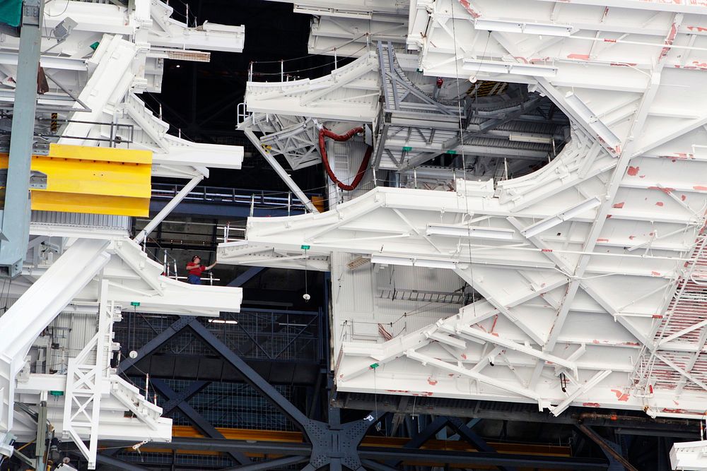 At NASA&rsquo;s Kennedy Space Center in Florida, a crane lowers a space shuttle-era work platform from high bay 3 inside the…