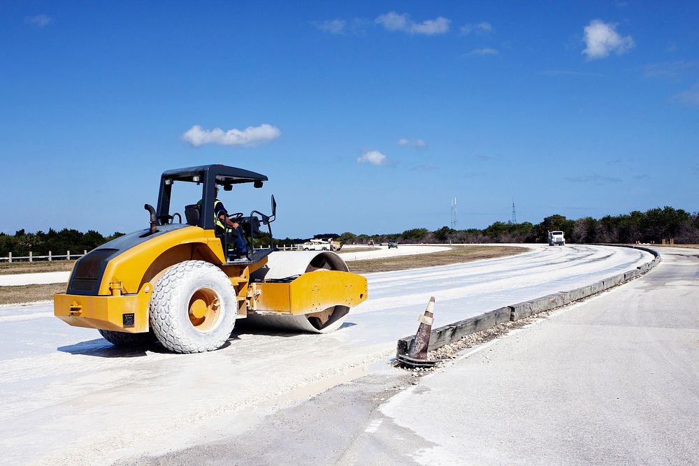 A worker from Canaveral Construction in Mims, Fla., re-grades a section of the lime rock on the crawlerway near Launch Pad…