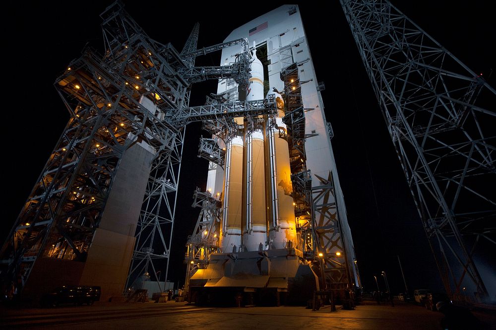The launch gantry is rolled back to reveal NASA's Orion spacecraft mounted atop a United Launch Alliance Delta IV Heavy…