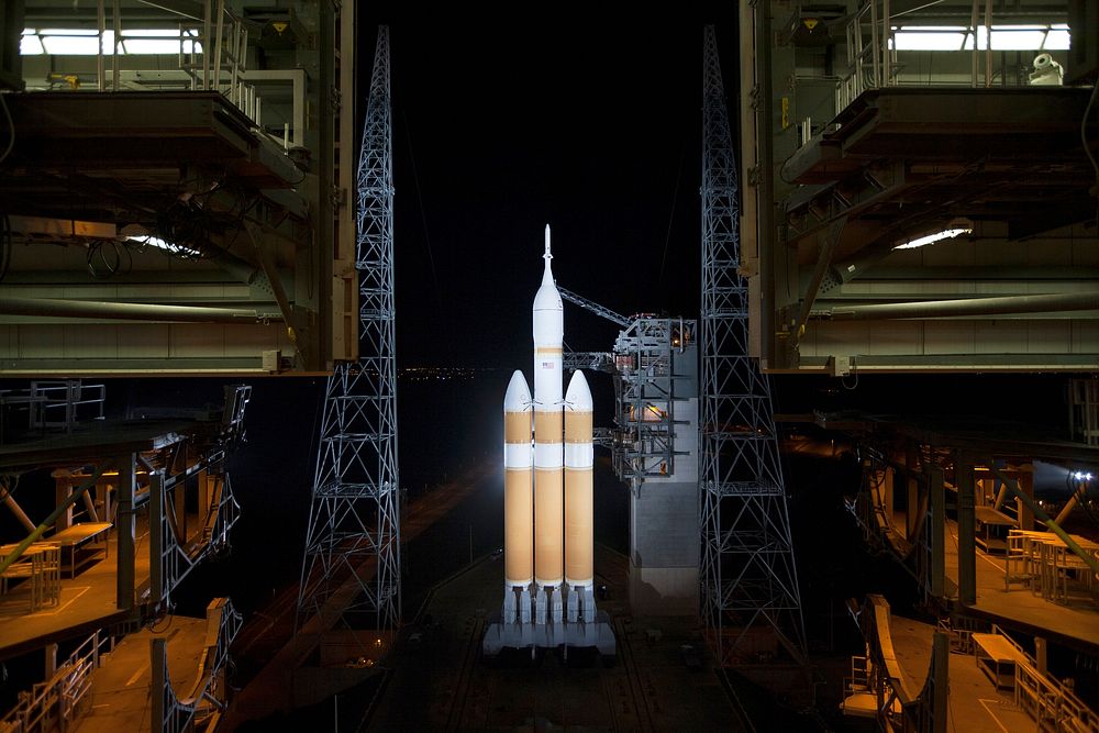 The launch gantry is rolled back to reveal NASA's Orion spacecraft mounted atop a United Launch Alliance Delta IV Heavy…