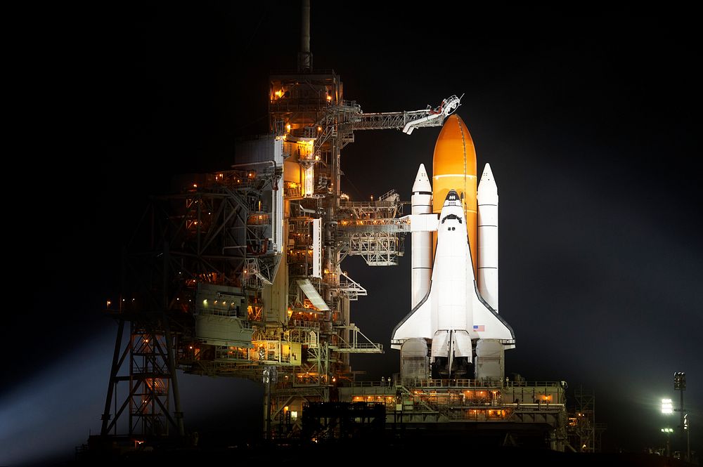The space shuttle Discovery is seen shortly after the Rotating Service Structure was rolled back at launch pad 39A, at the…