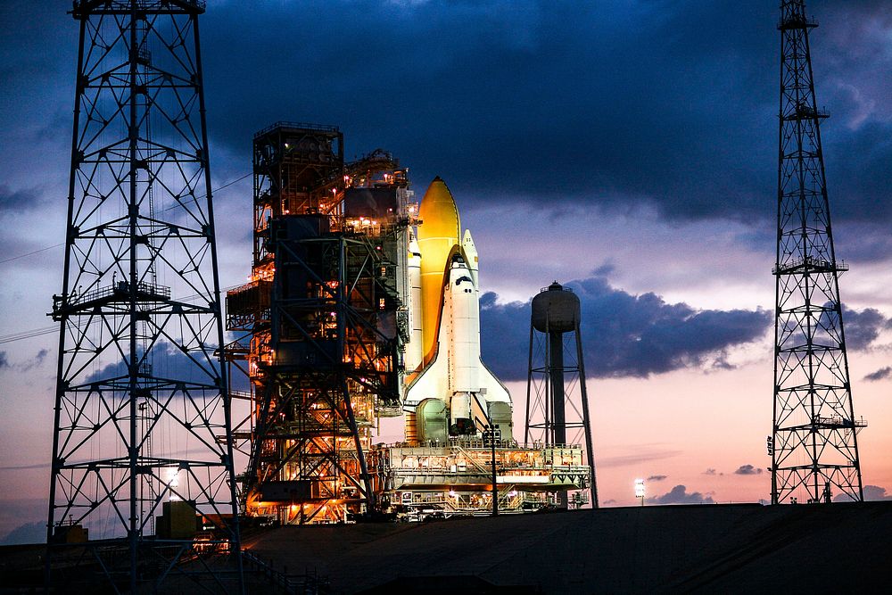 Just before dawn, space shuttle Endeavour is bathed in xenon lights after being secured on Launch Pad 39B. Original from…