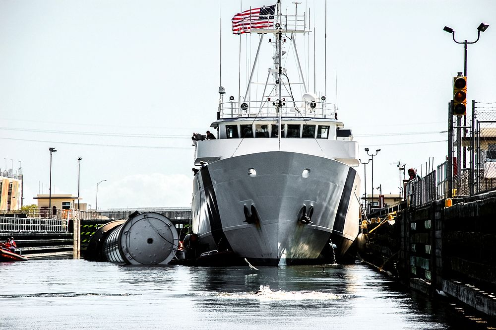 Liberty Star, one of NASA's solid rocket booster retrieval ships, ushers a spent shuttle booster to Hangar AF at Cape…