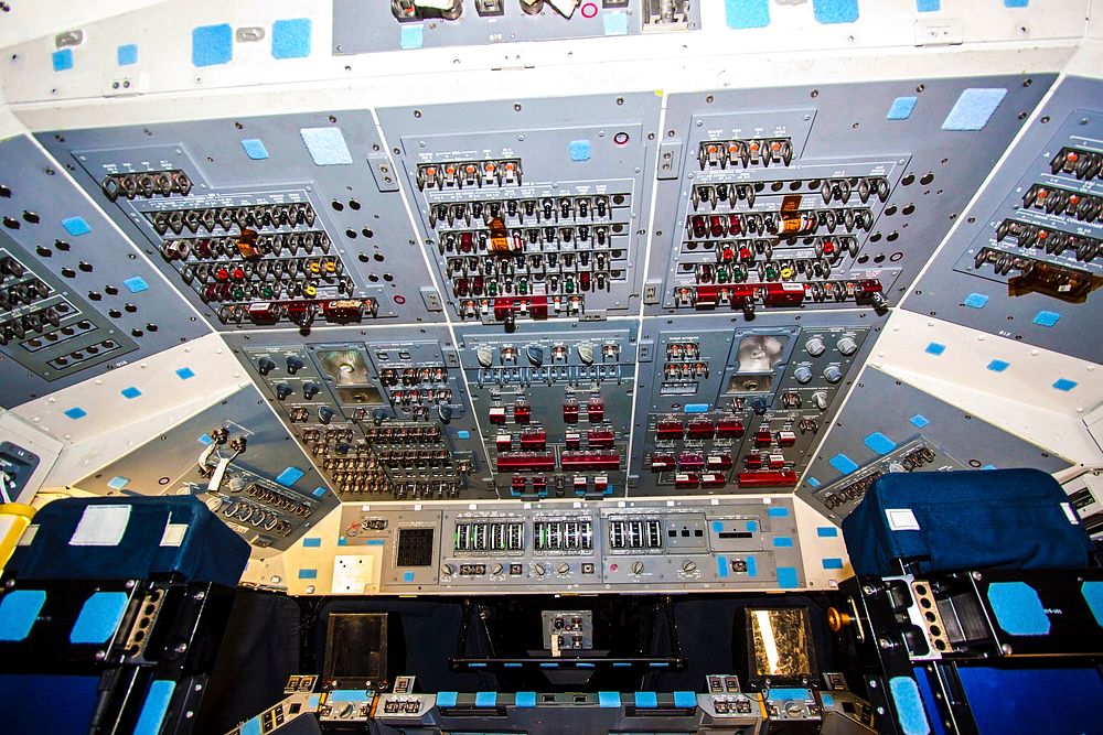 In Orbiter Processing Facility-2 at NASA's Kennedy Space Center in Florida, the flight deck of space shuttle Atlantis is lit…