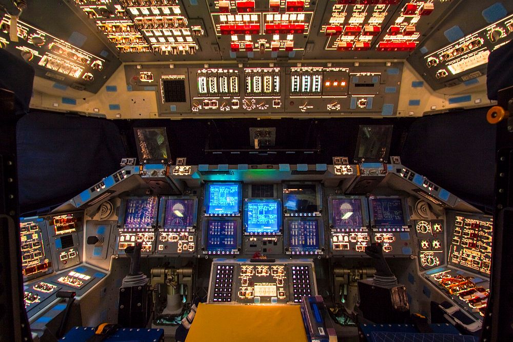 In Orbiter Processing Facility-2 at NASA's Kennedy Space Center in Florida, the flight deck of space shuttle Atlantis is lit…