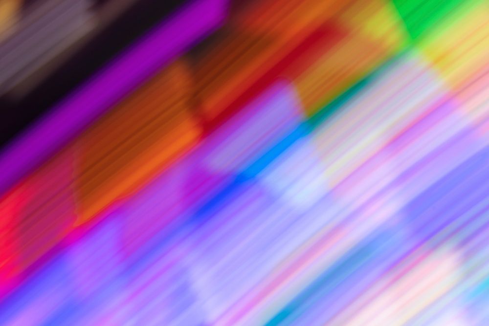 Defocused colorful neon lights from an amusement park background