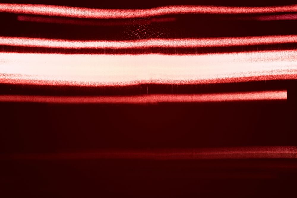 Neon lights reflected on red background 