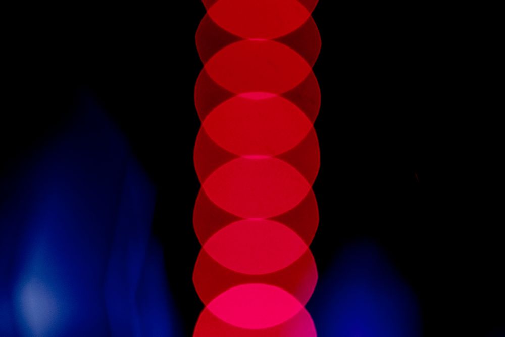 Red blurred lights on dark blue background