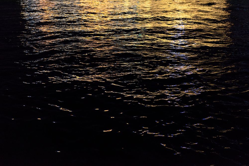 Lights on dark water textured background