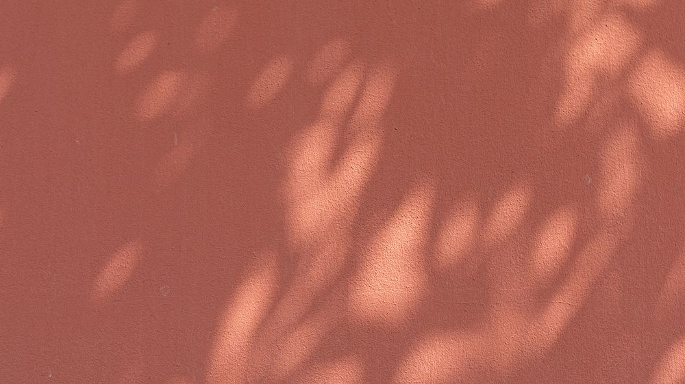 Tropical leaf computer wallpaper, shadow on pinkish brown background
