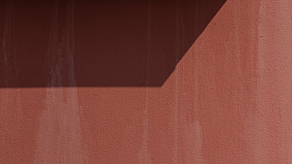 Natural light on a red concrete wall