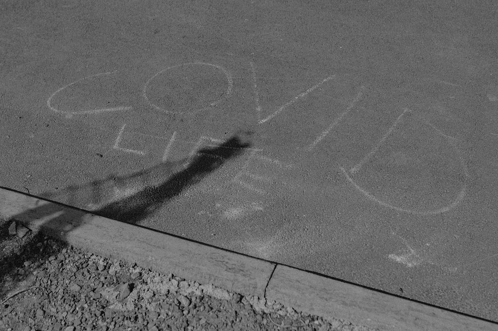 COVID life phrase written on the street