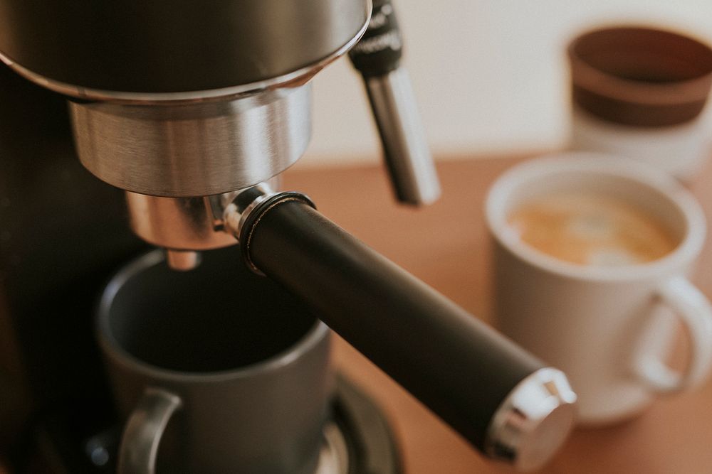 Close up of coffee maker and fresh coffee in a cup