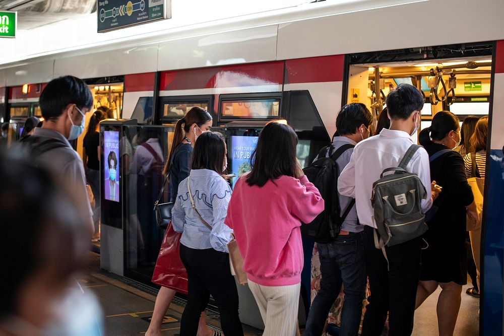 People getting on Bangkok BTS Skytrain. BANGKOK, THAILAND, 16 APRIL 2021