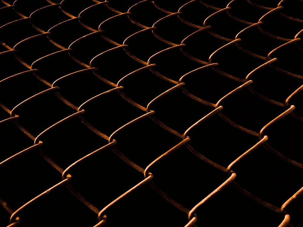Welded mesh fence at night