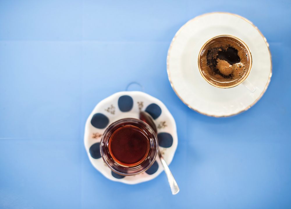 Aerial view of coffee cups on blue table