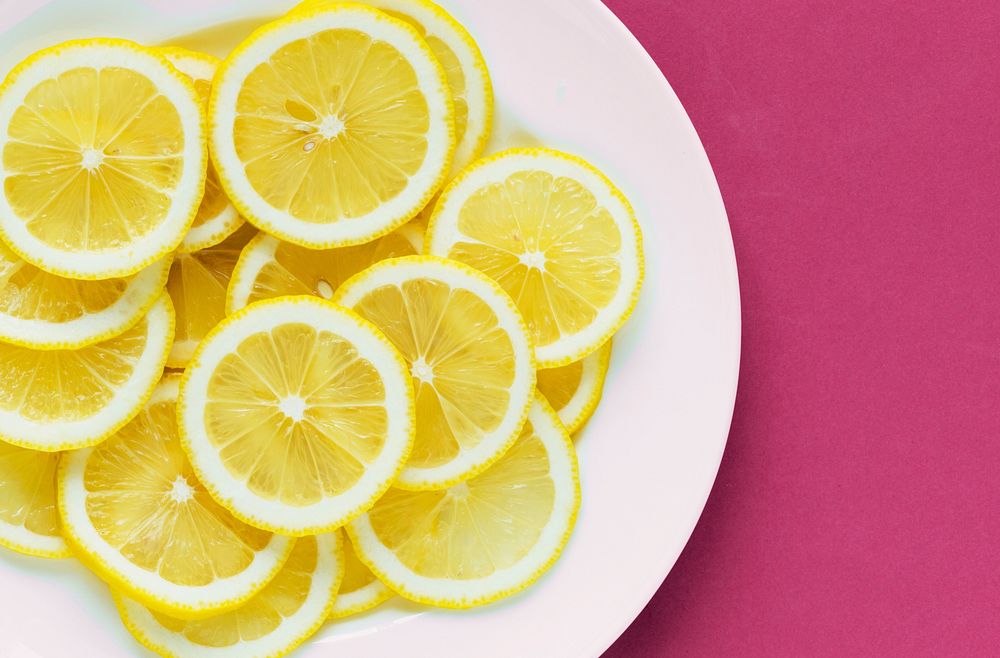Closeup of a plate of sliced lemon textured background