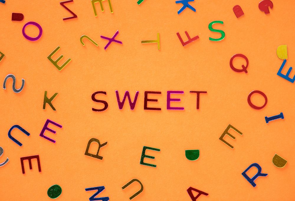 Sweet spelled word with alphabets background