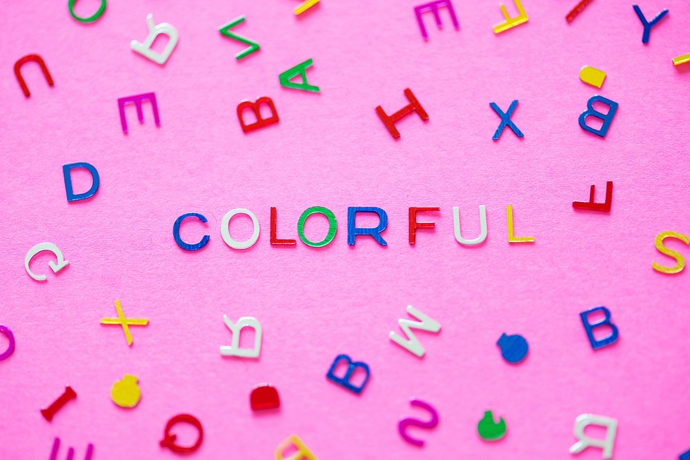 Colorful spelled word with alphabets background