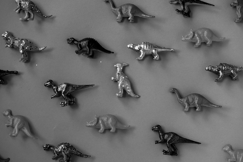 Metallic sprayed plastic diosaur figurine patterned background