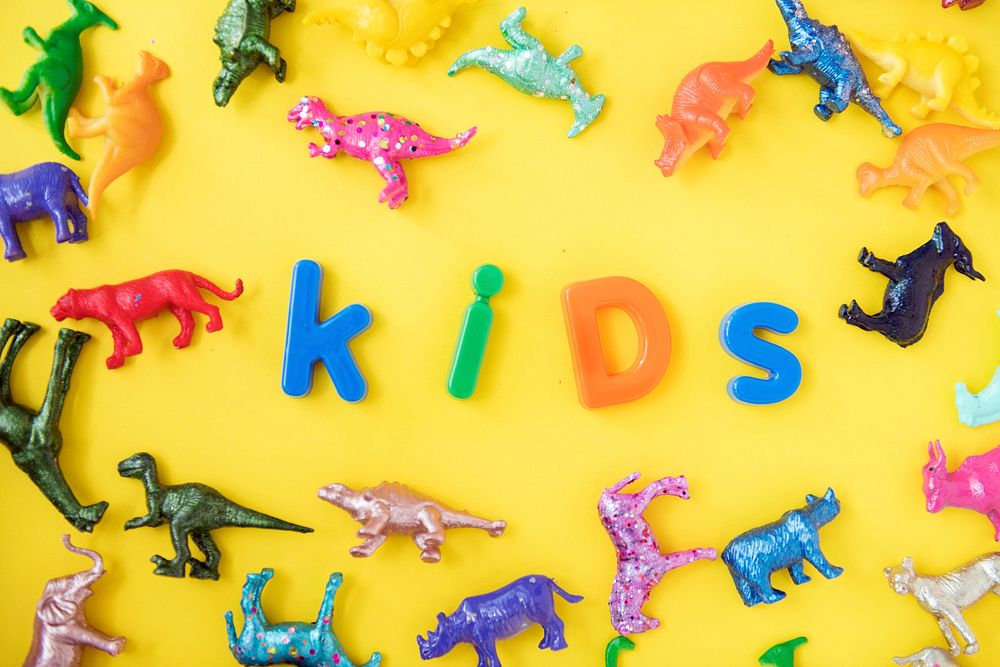 Various animal toy figures background with the word kids