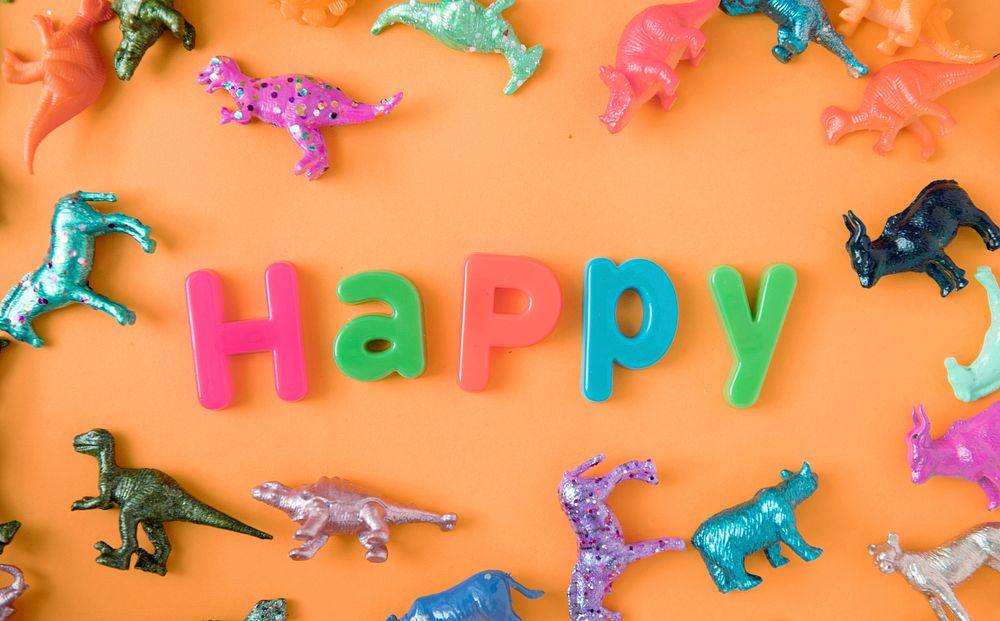 Various animal toy figures background with the word happy