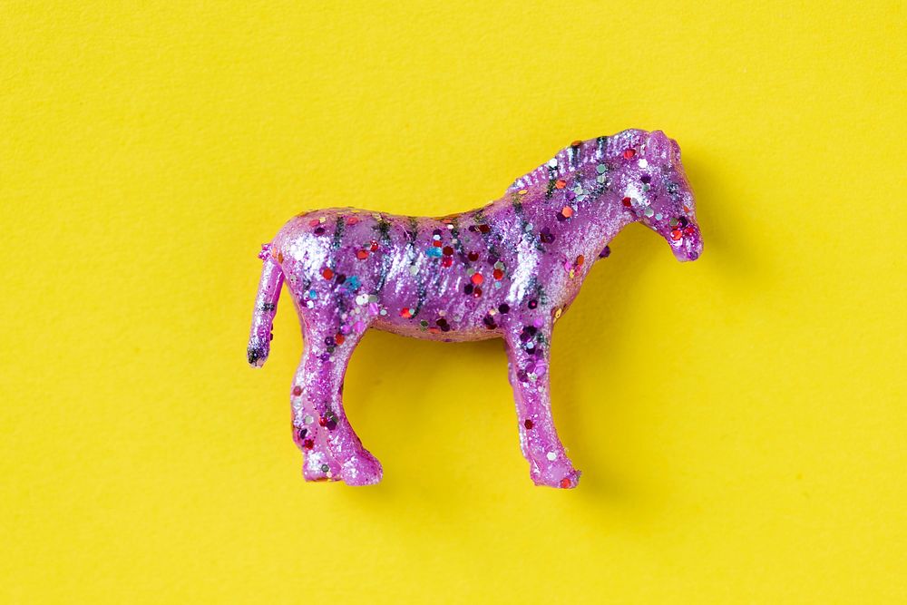 Aerial view of horse figurine toy in a colorful background
