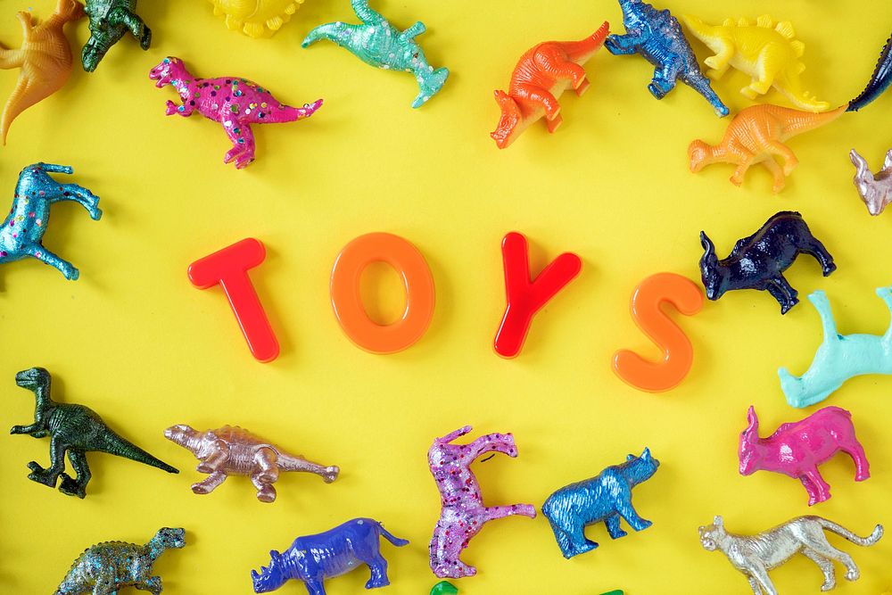 Various animal toy figures background with the word toys