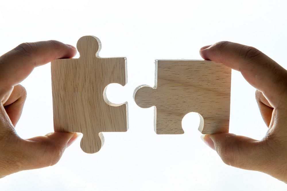 Macro shot of jigsaw puzzles teamwork concept