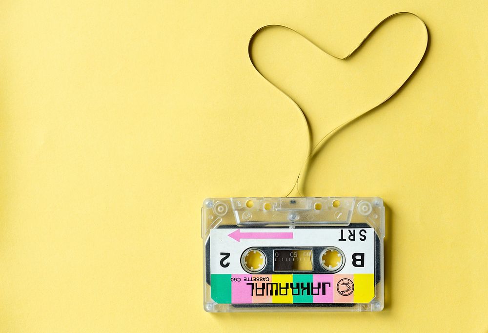 Cassette tape with a heart symbol isolated on yellow background