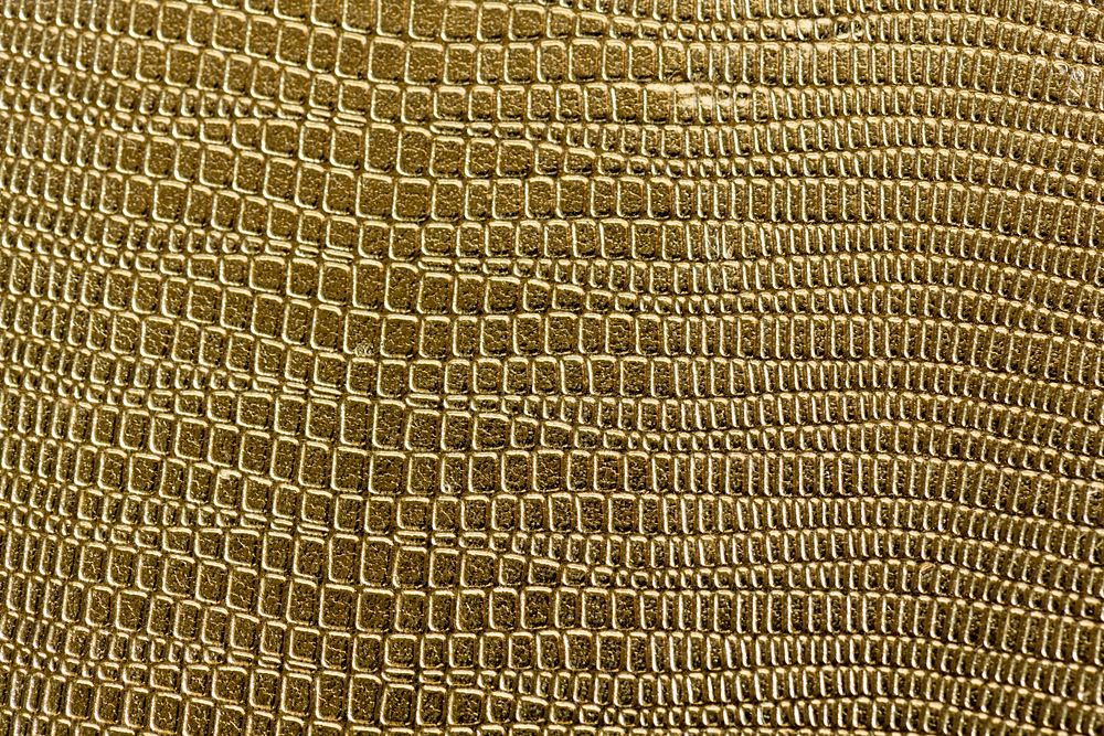 Closeup of golden scaly textured pattern background