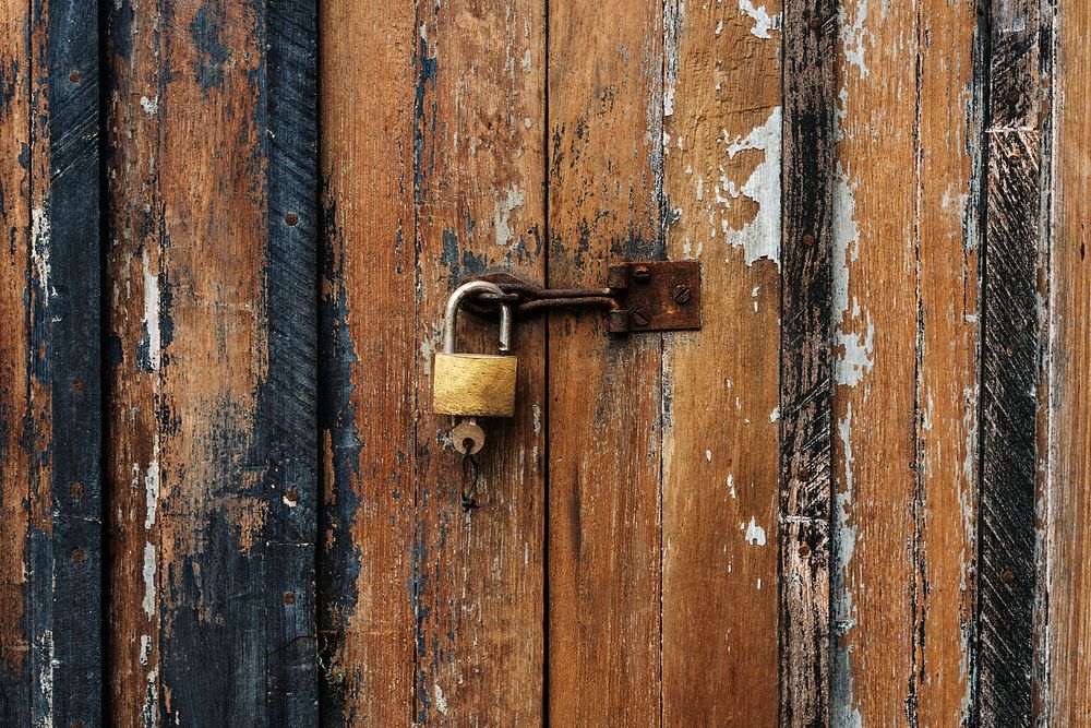 Wooden door with a padlock and a key