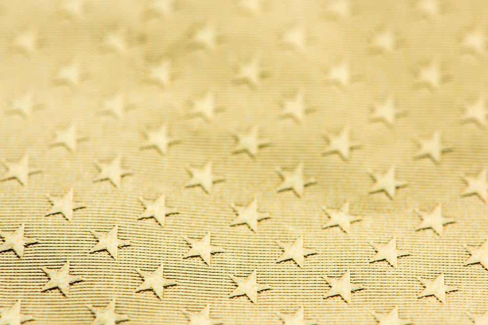 Shiny gold textured star patterned paper background