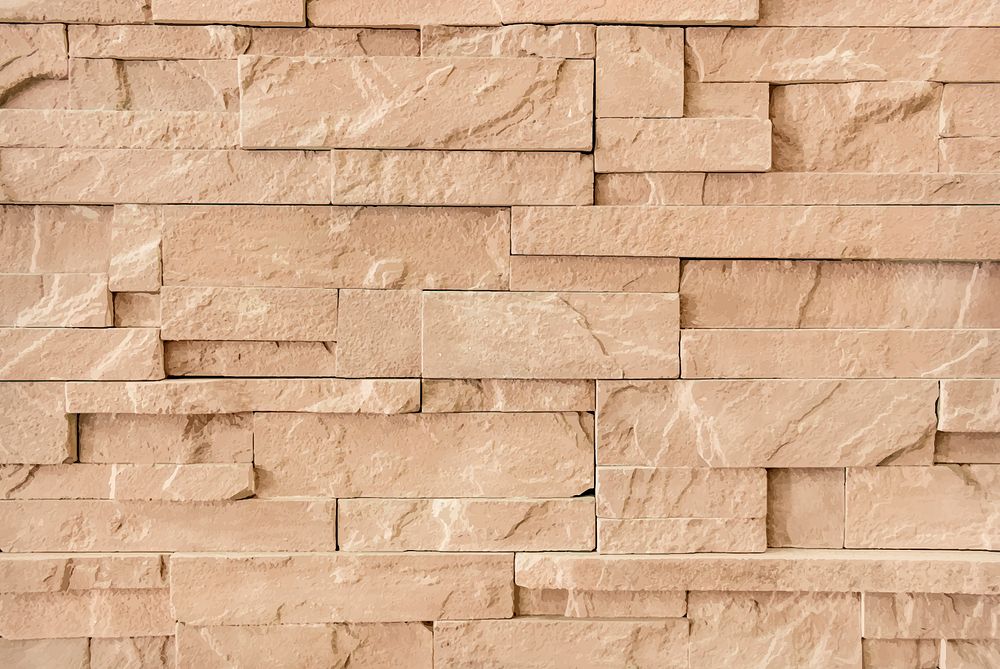 Brown sandstone brick wall textured wallpaper vector