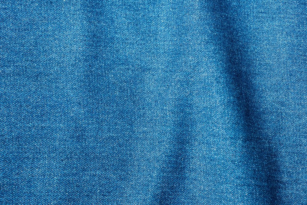 Wavy blue denim fabric textured background