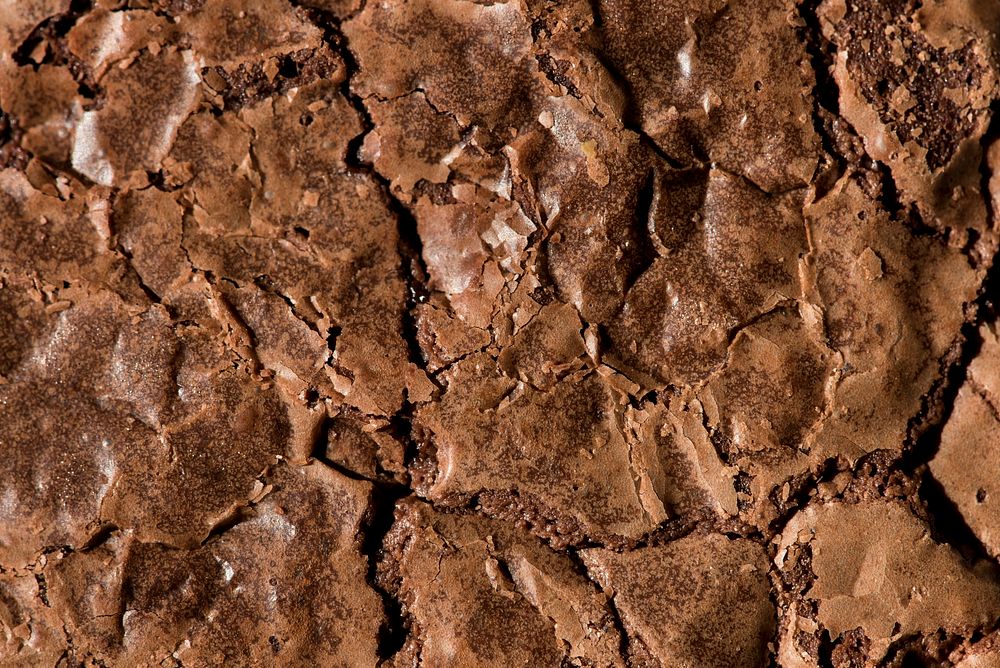 Baked cracked brownie surface textured background